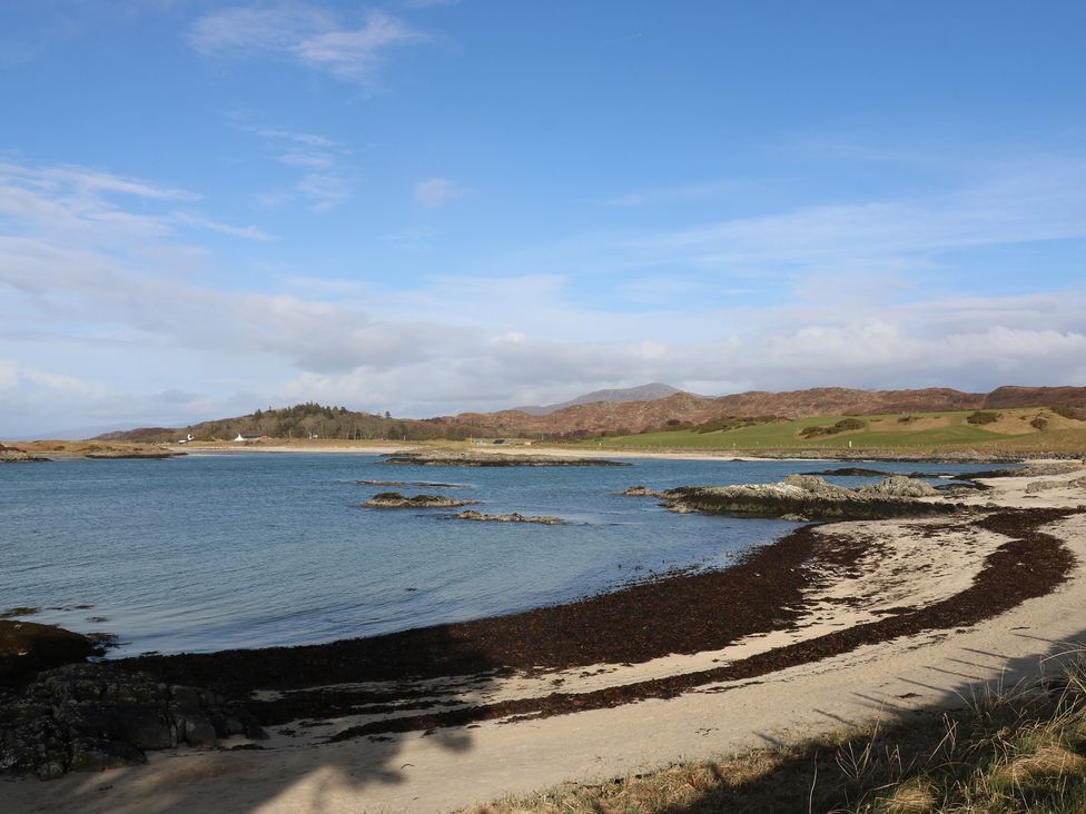 A beach scene with water and rocks at Island View Lodge Back of Keppoch near Arisaig