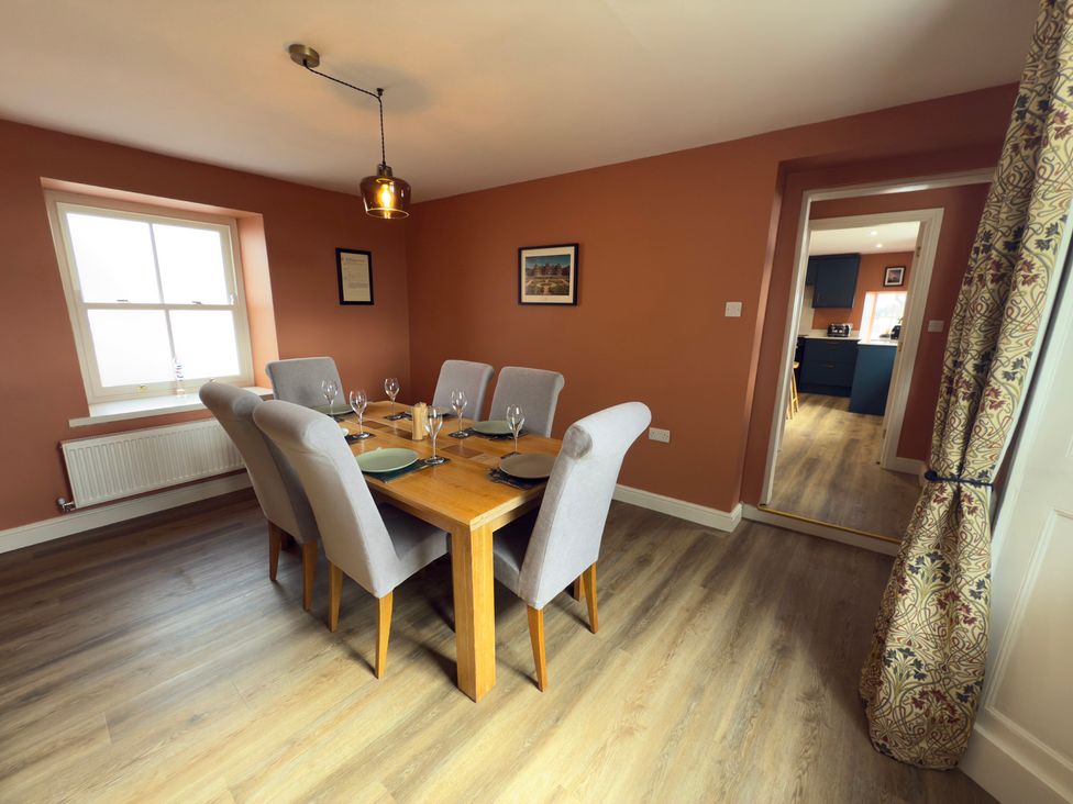 A dining room with a table and chairs at Peace Cottage in Langton near Gainford