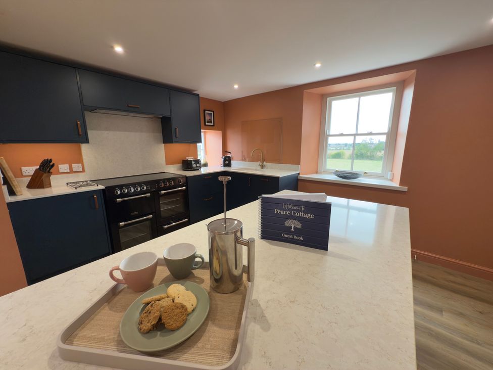 A kitchen with cabinets and coffee setup at Peace Cottage in Langton near Gainford