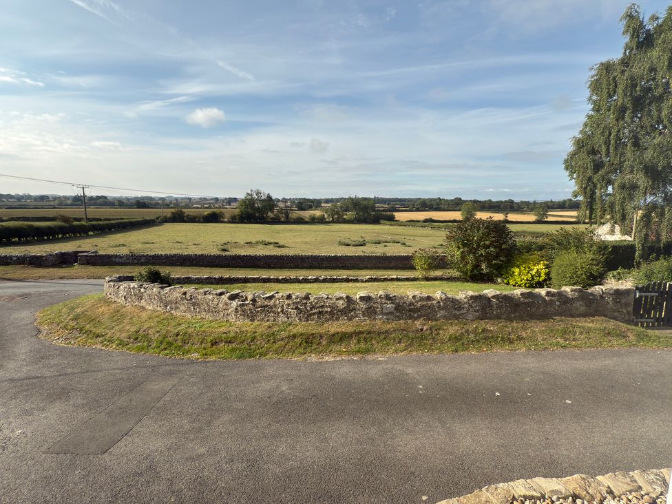 A view of fields and a stone wall at Peace Cottage in Langton near Gainford