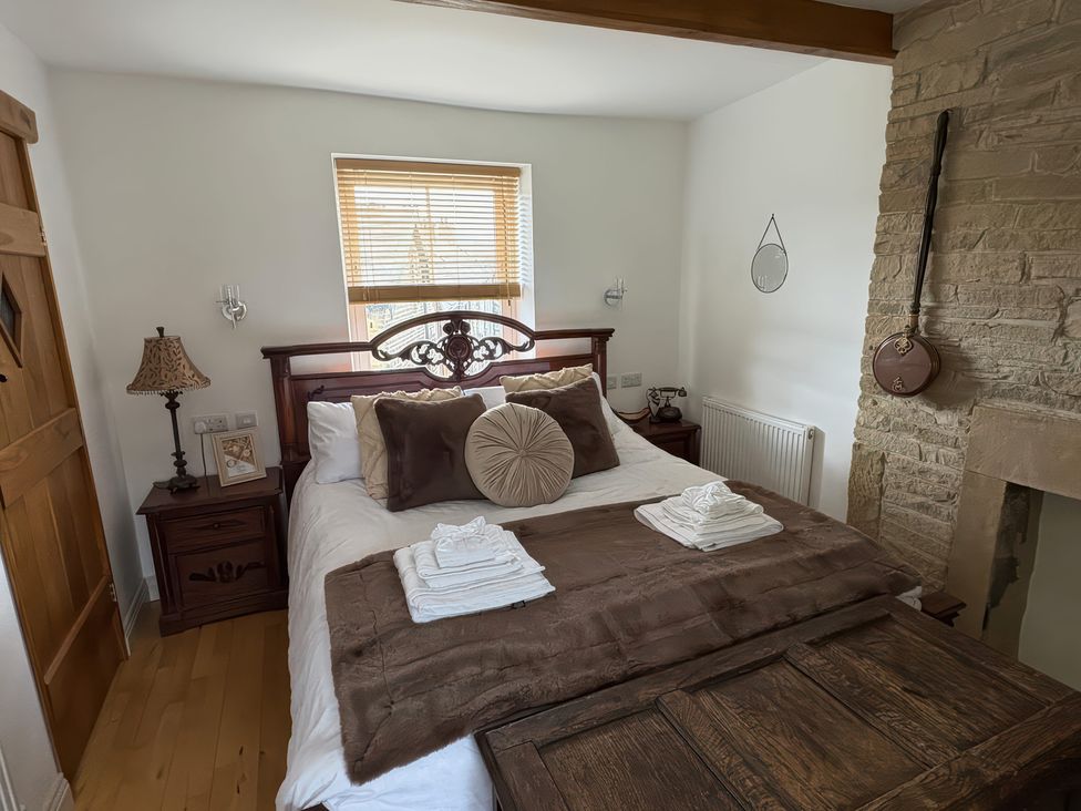 A bedroom with a bed and bedside table at 12 Queen Street in Keighley