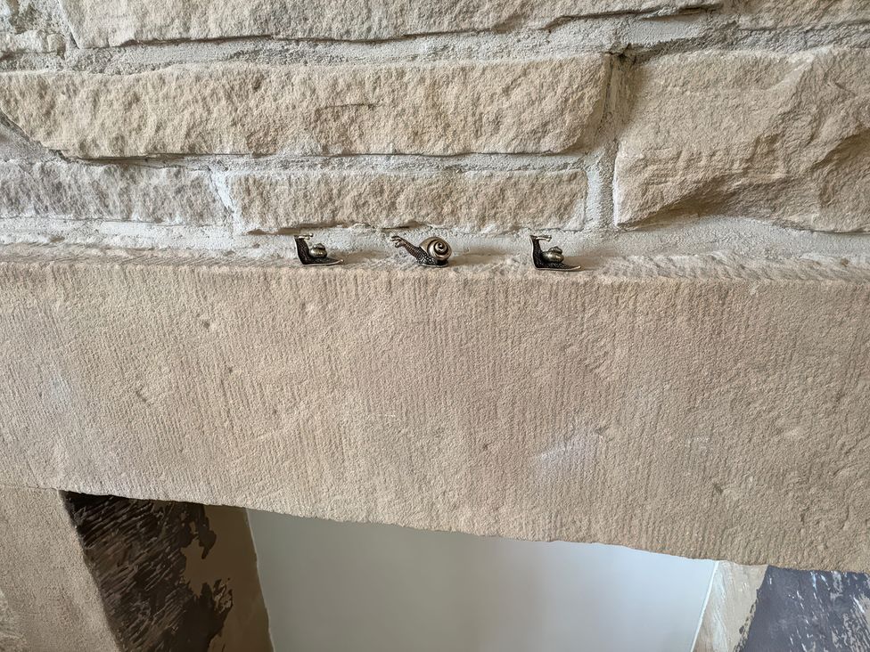 A stone mantel with decorative snails at 12 Queen Street Keighley