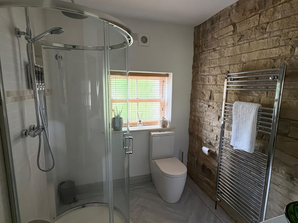 A bathroom with a shower and toilet at 12 Queen Street in Keighley