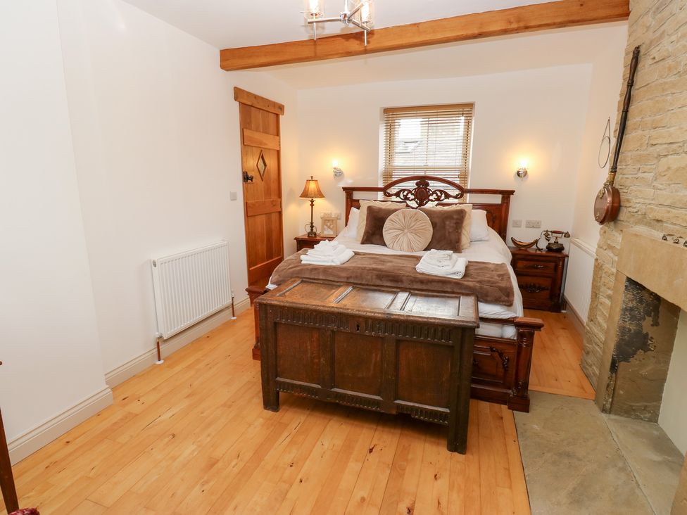 A bedroom with a bed and a wooden chest at Hivewood Cottage in Haworth