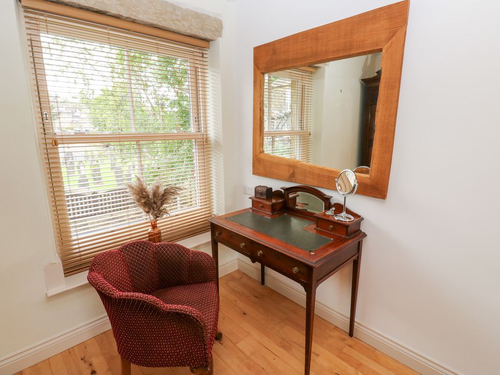 A home office with a desk and chair at Hivewood Cottage in Haworth