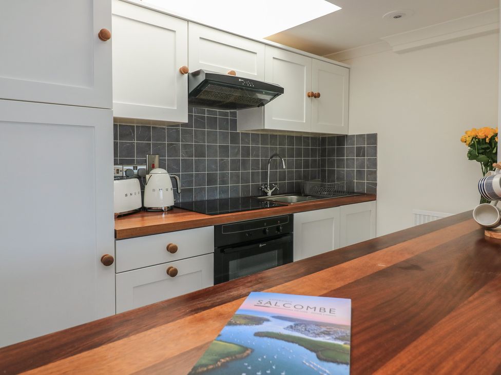 A kitchen with a sink and countertop at 43 The Salcombe, Salcombe
