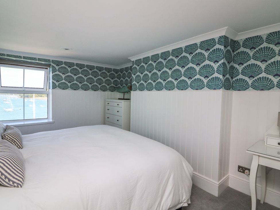 A bedroom with a bed and window at 43 The Salcombe in Salcombe