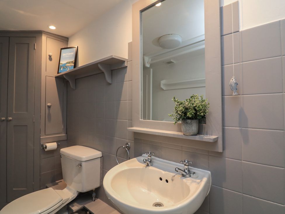 A bathroom with a sink and toilet at 43 The Salcombe in Salcombe