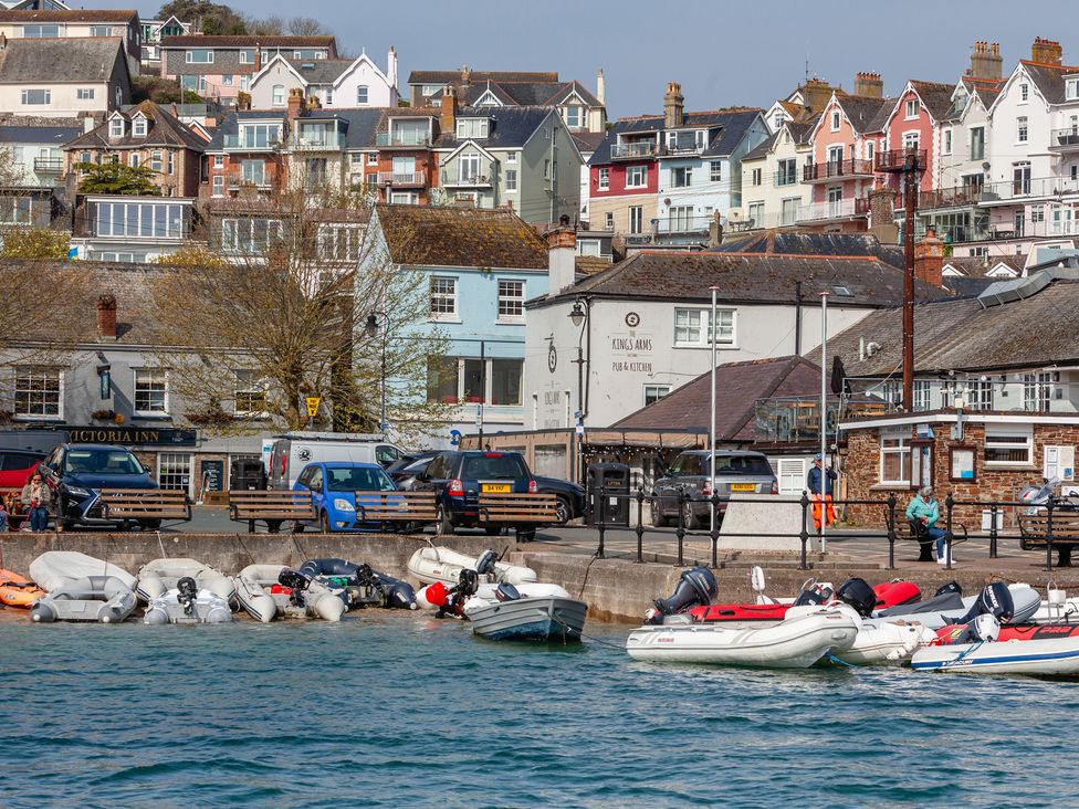 A view of boats and a pub with cars parked at 43 The Salcombe in Salcombe