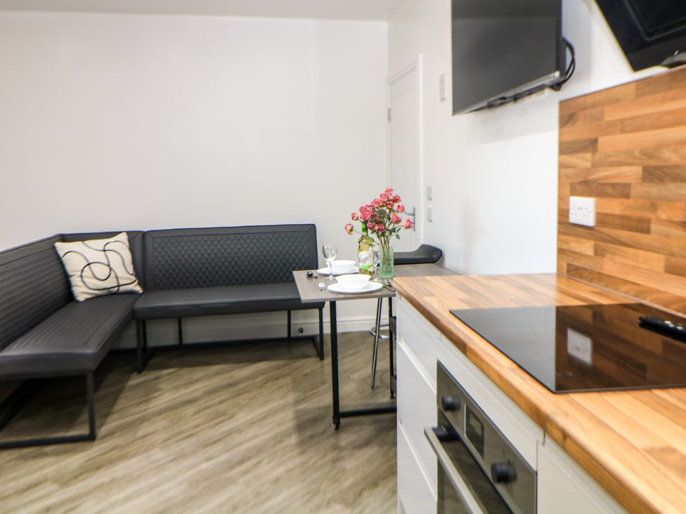 A kitchen with a sofa and table at Don Valley Apartment A