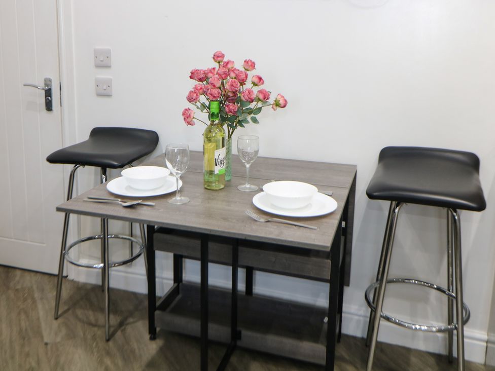 A dining area with a table set for two at Don Valley Apartment A