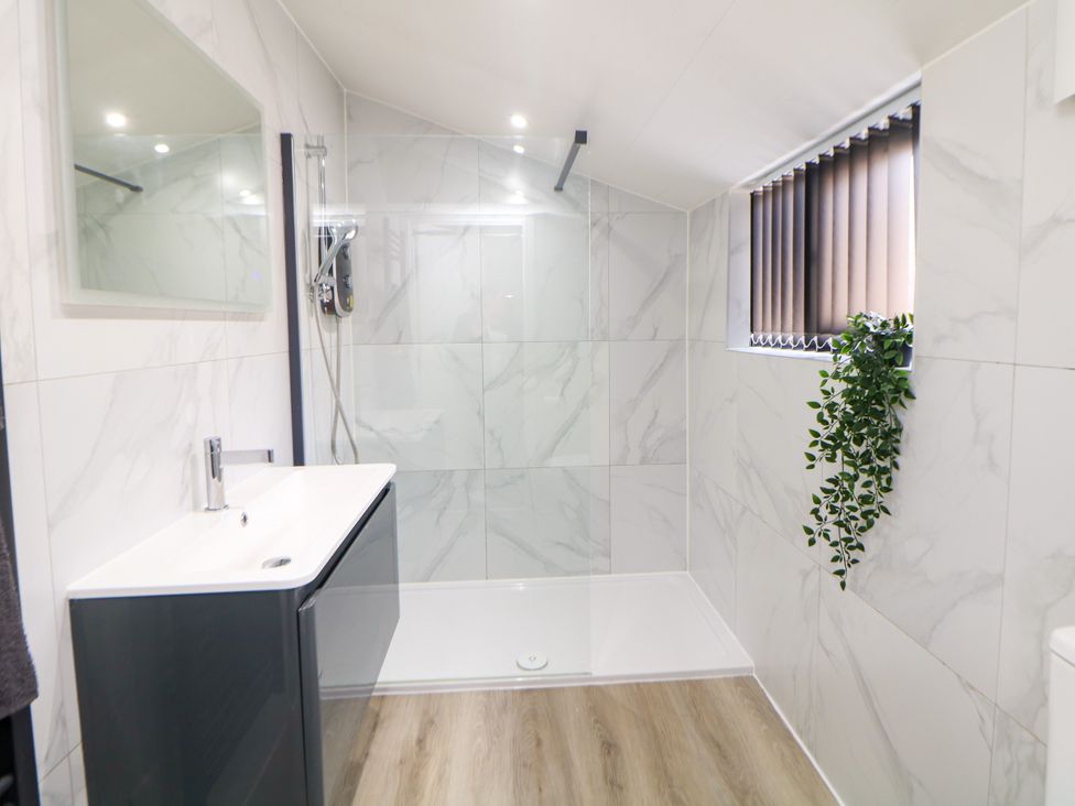 A bathroom featuring a shower and vanity unit at Don Valley Apartment A