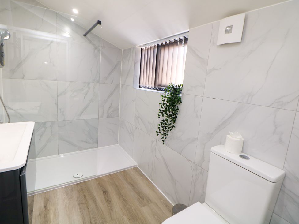 A bathroom with a shower and toilet at Don Valley Apartment A
