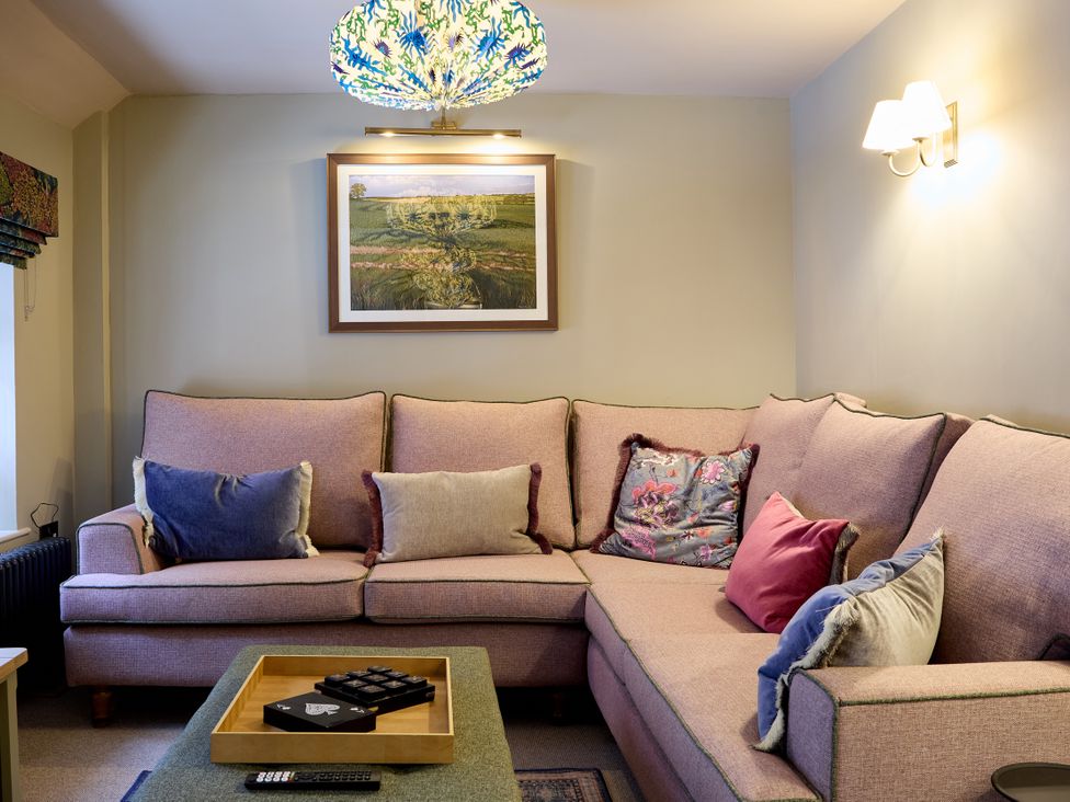 A living room with a sofa and table at The Dovecote in Matlock