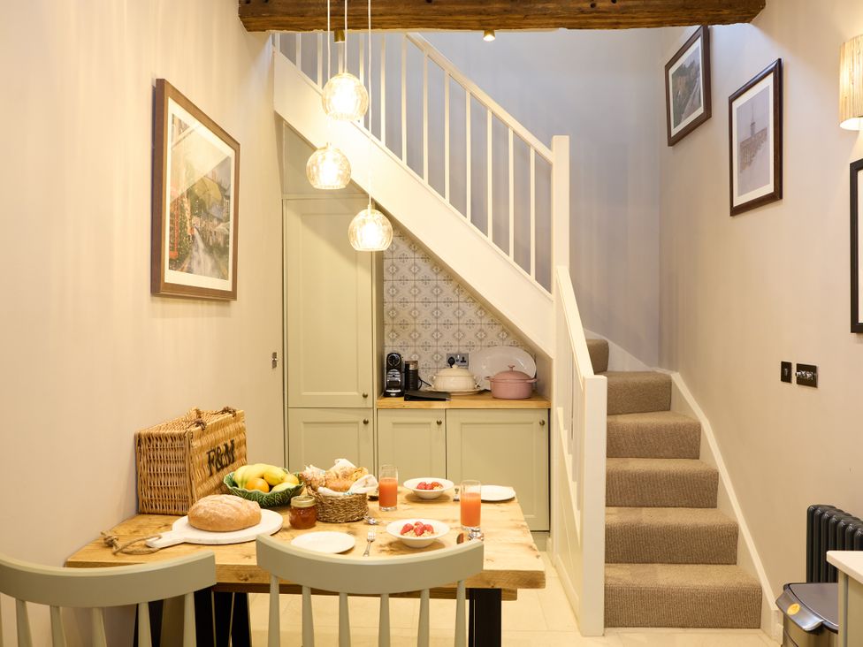 A kitchen with a table set for breakfast at The Dovecote in Matlock