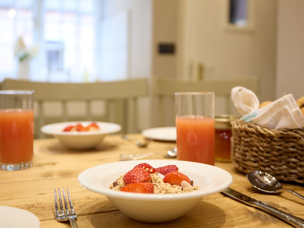 A dining table setting with cereal and juice at The Dovecote in Matlock