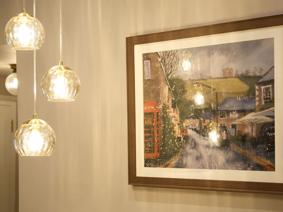 A room with hanging light fixtures and a framed picture at The Dovecote in Matlock