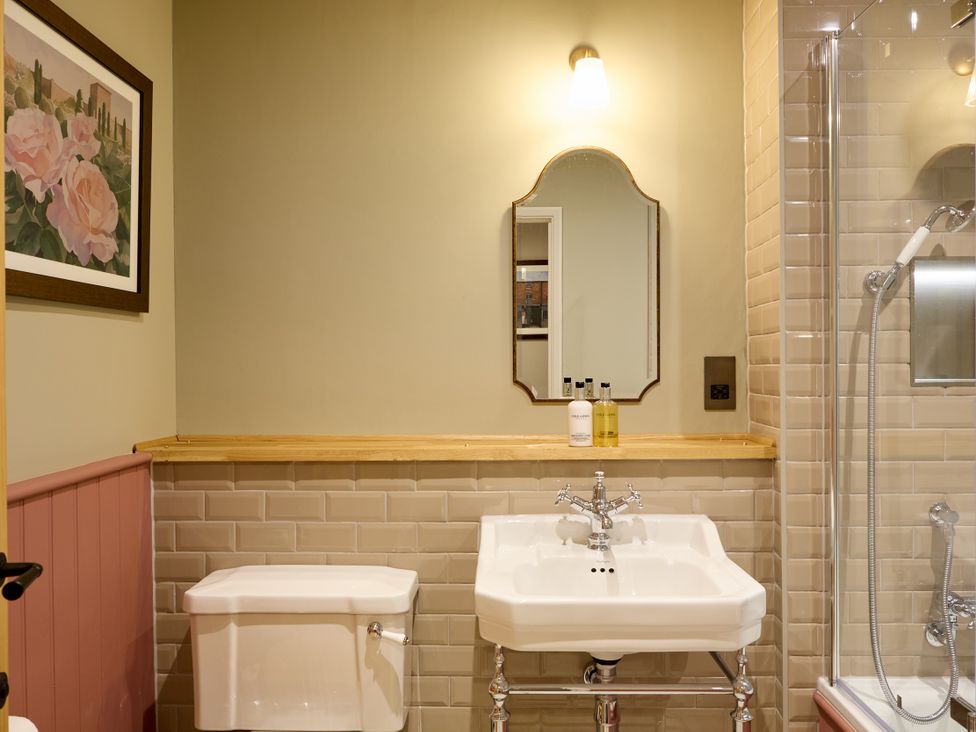 A bathroom with a sink and shower at The Dovecote in Matlock