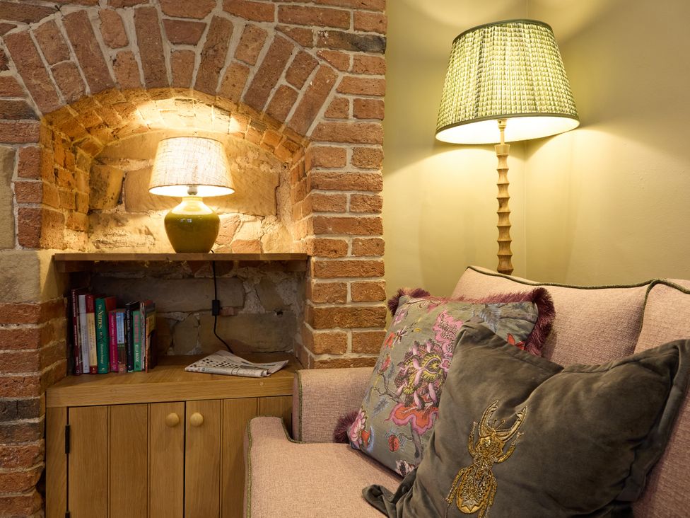 A snug with a sofa and lamp at Butler's Quarters in Matlock