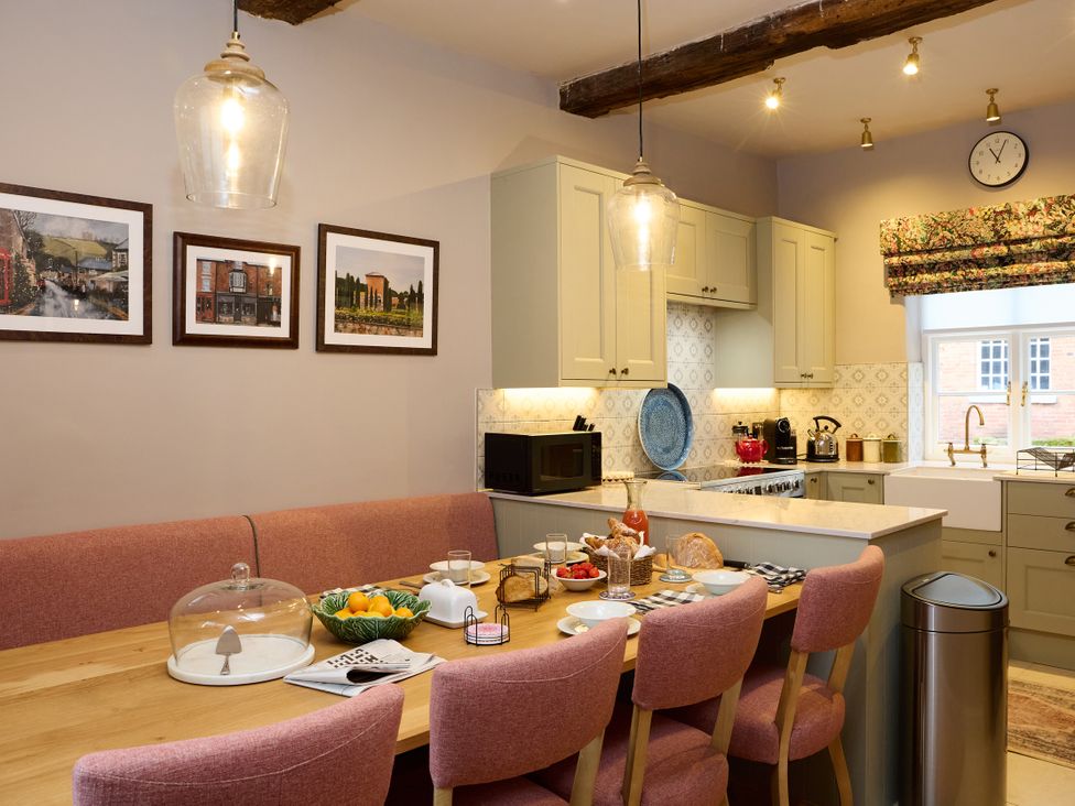 A kitchen with a dining table and chairs at Butler's Quarters in Matlock