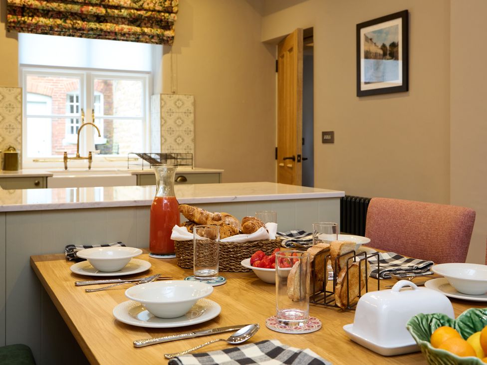 A dining room with a table set for breakfast at Butler's Quarters in Matlock