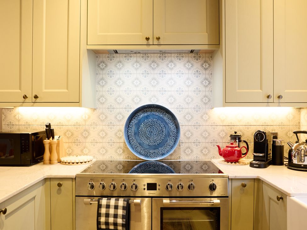 A kitchen with an oven, microwave, and coffee machine at Butler's Quarters in Matlock