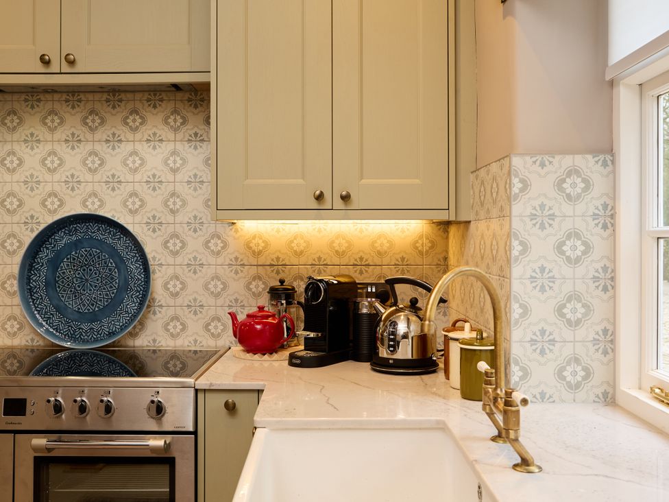 A kitchen with a coffee machine and kettle at Butler's Quarters in Matlock