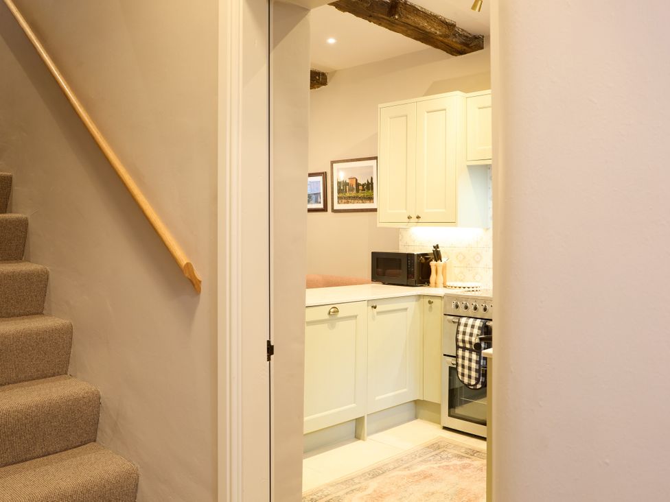 A kitchen with a staircase in view at Butler's Quarters in Matlock
