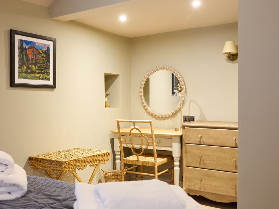 A bedroom with a vanity table and chair at Butler's Quarters in Matlock