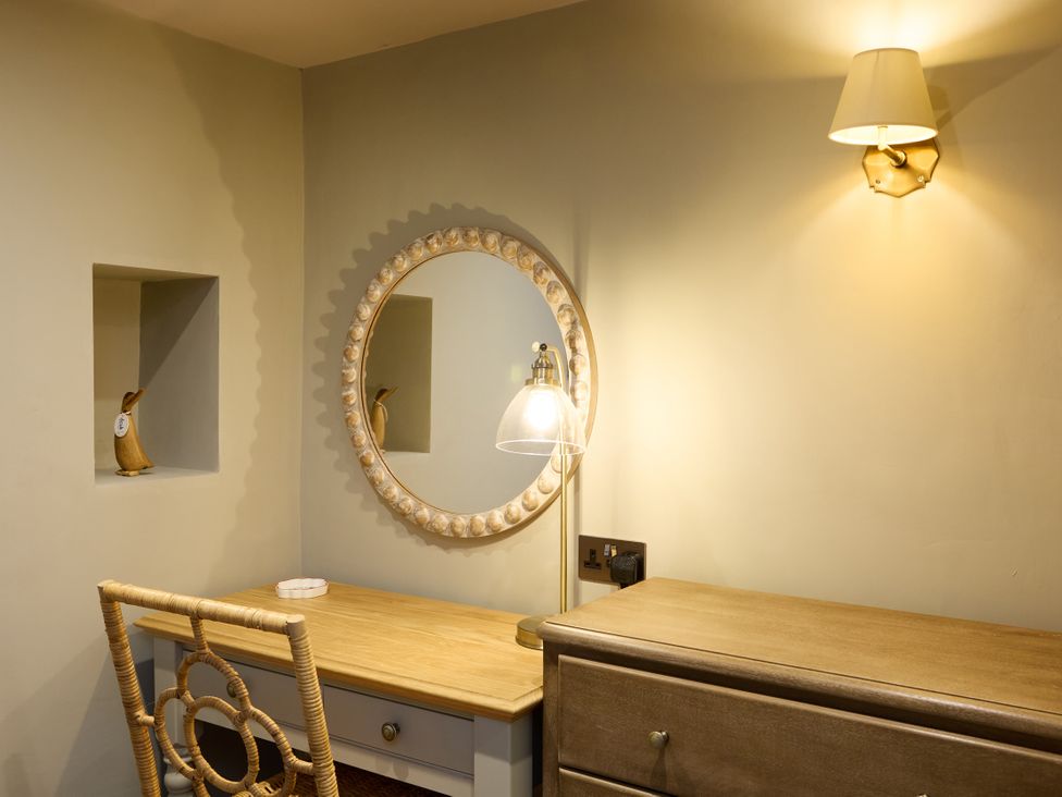 A snug with a desk and a mirror at Butler's Quarters in Matlock