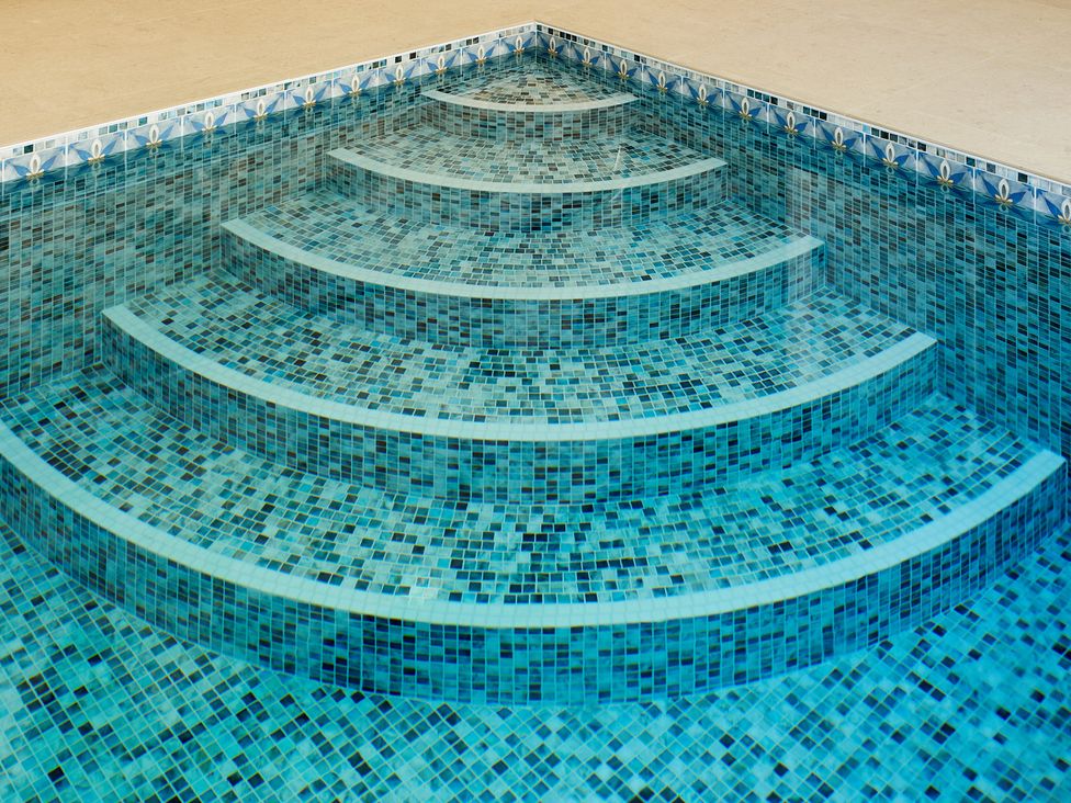 A swimming pool with tiled steps at Gardeners Cottage in Hopton