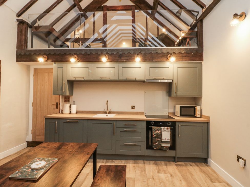 A kitchen with cabinets and appliances at Dotty's Den in Bridlington