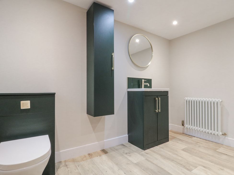 A bathroom with sink and mirror at Dotty's Den in Bridlington