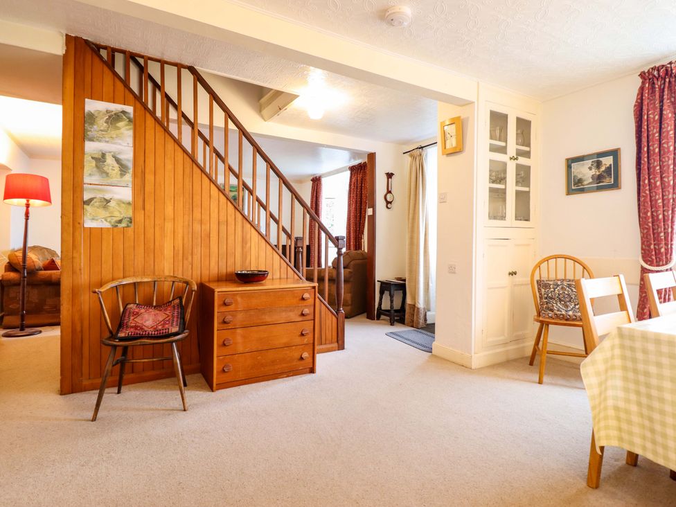 A living room with a staircase and furniture at Garth Celyn in Porthmadog