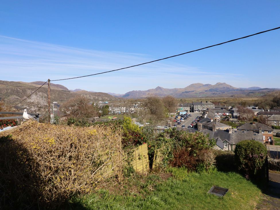 A landscape view of a town with mountains in the background at Garth Celyn in Porthmadog