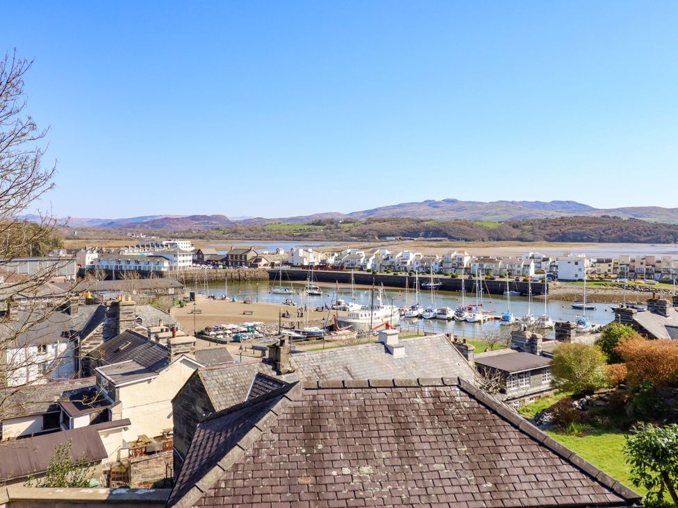 A view of boats and buildings near water at Garth Celyn in Porthmadog
