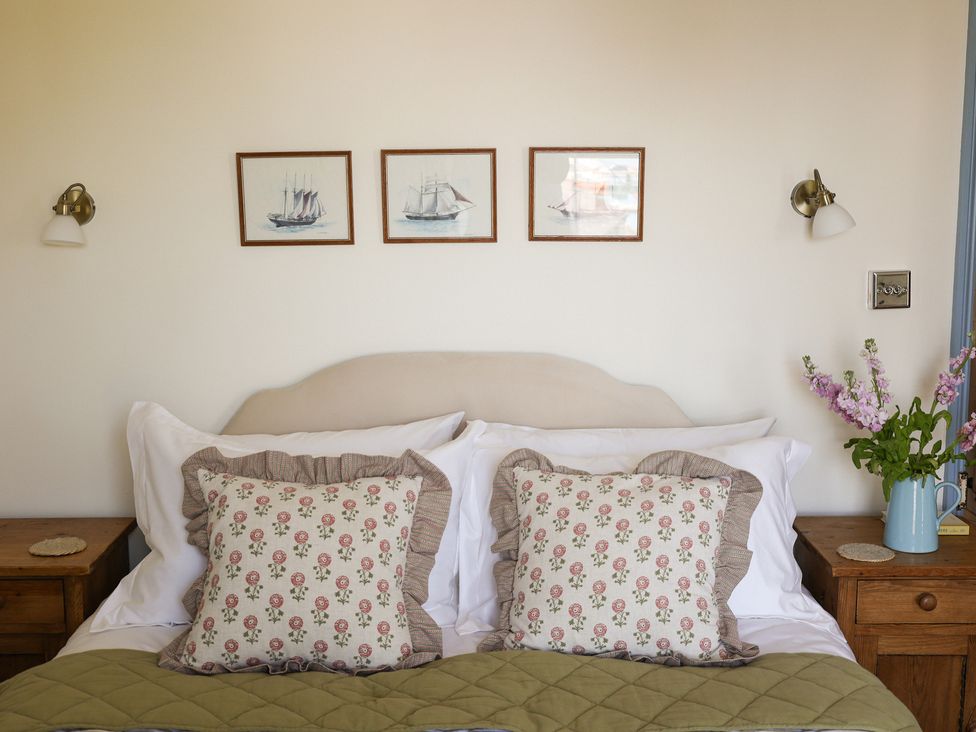 A bedroom with a bed and pillows at Kittiwake in Newlyn