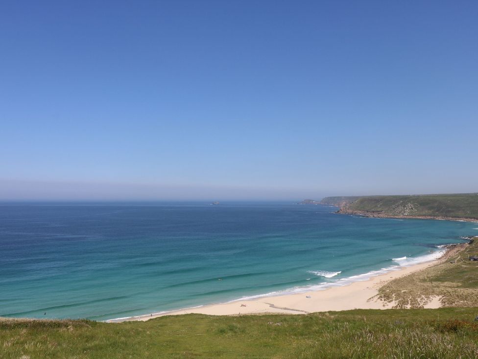 A beach with waves and coastline at Kittiwake in Newlyn
