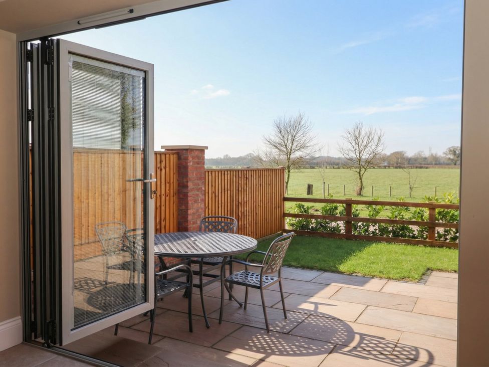 An outdoor space with a table and chairs at Stable End Cottage Cuckoo Nest Farm near Wilberfoss