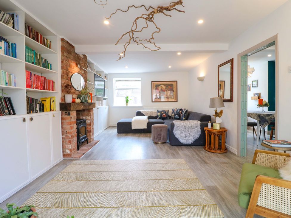 A living room with a fireplace and bookshelves at 83 Meeting Street in Quorn