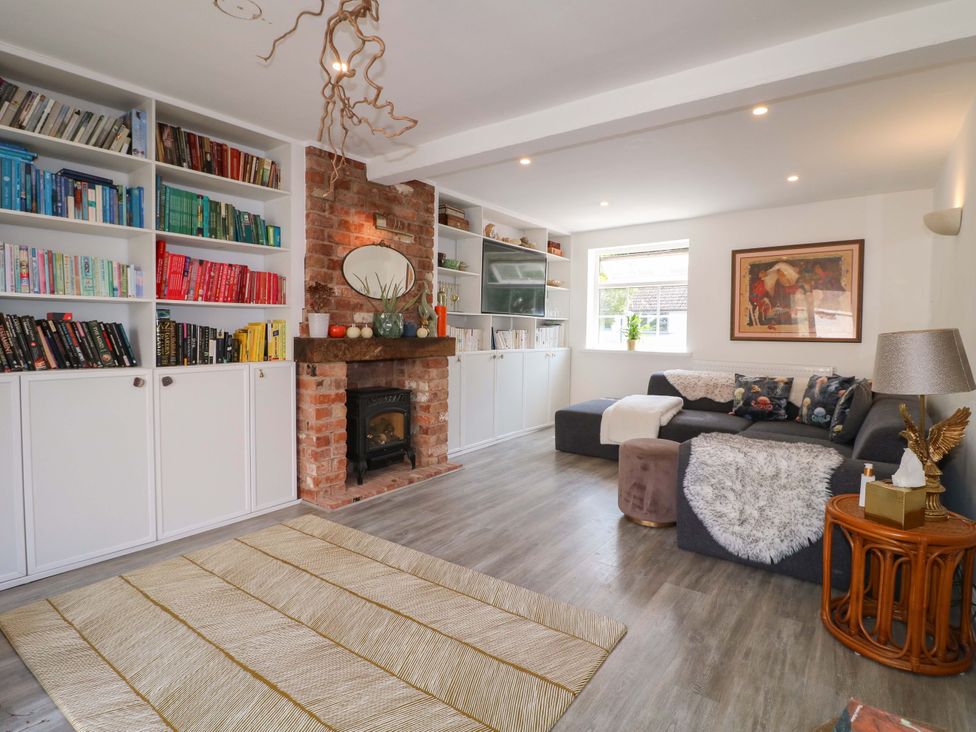 A living room with a bookshelf and fireplace at 83 Meeting Street in Quorn