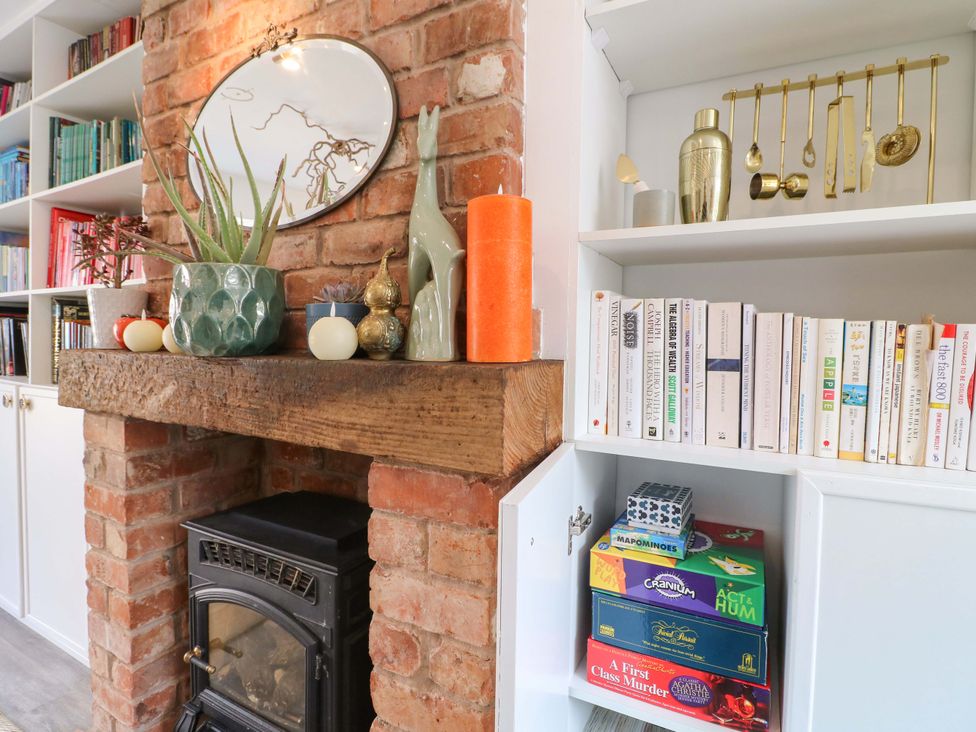 A living room with a fireplace and bookshelves at 83 Meeting Street Quorn