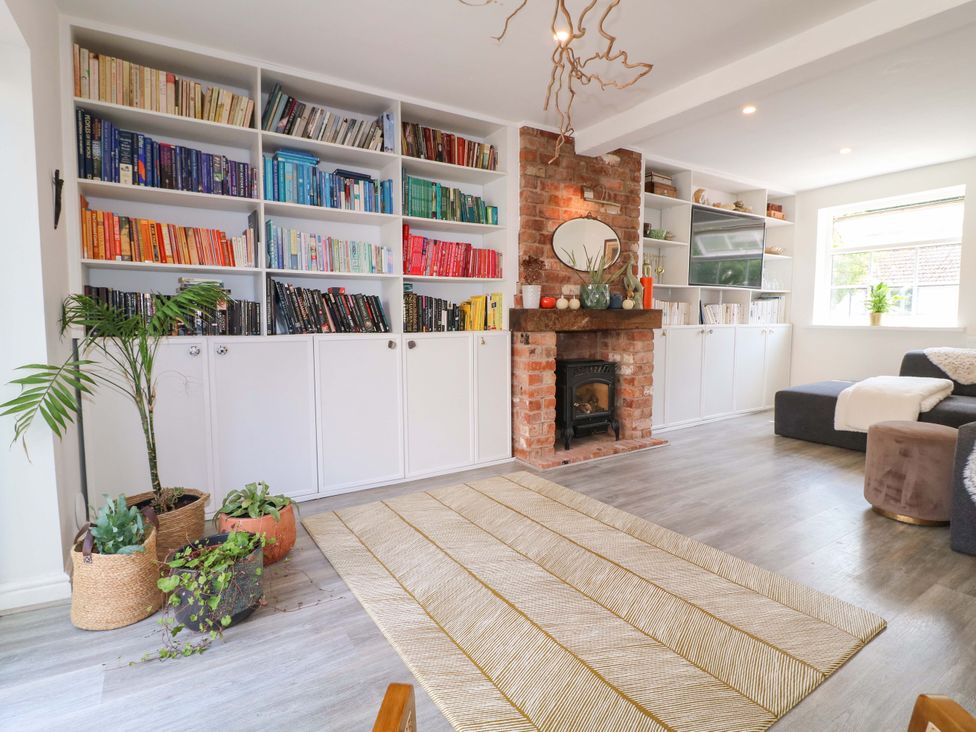 A living room with a bookshelf and fireplace at 83 Meeting Street in Quorn