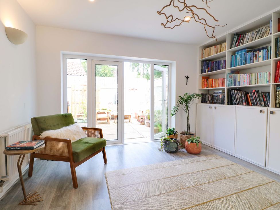 A snug with a chair and bookshelf at 83 Meeting Street Quorn