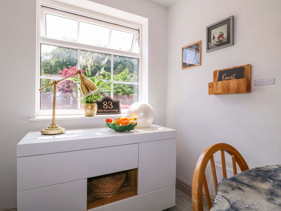 A dining room with a table and window at 83 Wild Peace Cottage in Quorn