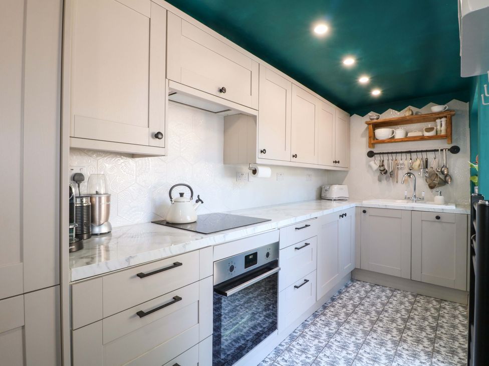 A kitchen with cabinets, sink, stove, and appliances at 83 Meeting Street in Quorn