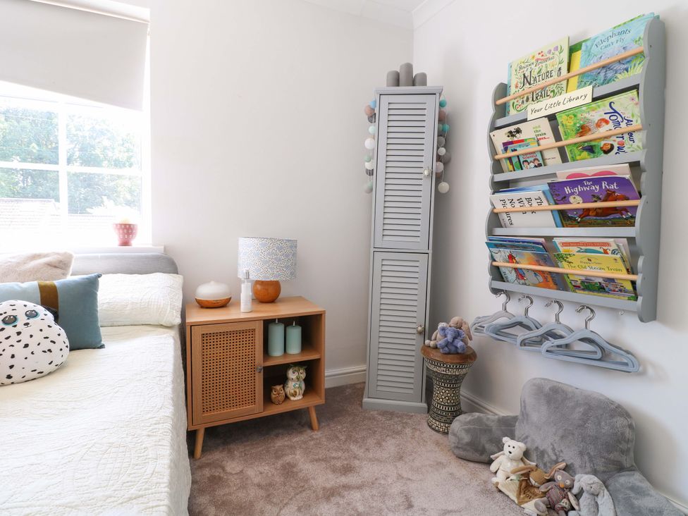 A bedroom with a bed and bookshelf at 83 Meeting Street in Quorn