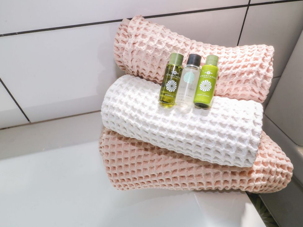 Towels and bath products on a surface at 83 Meeting Street Quorn