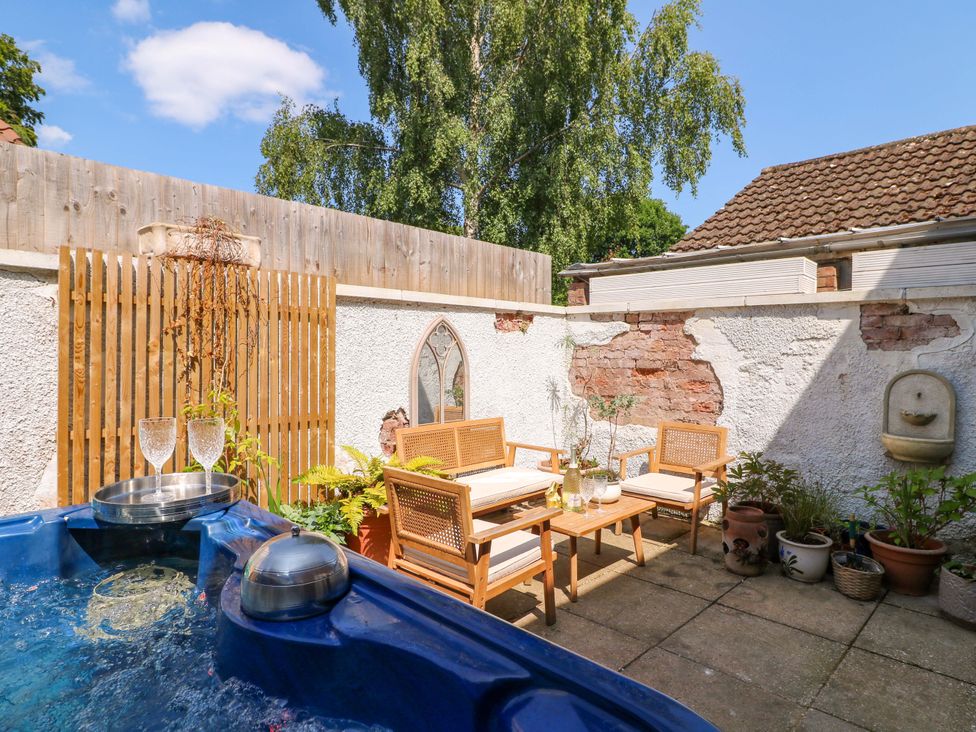 An outdoor space with a hot tub and seating area at 83 Meeting Street Quorn