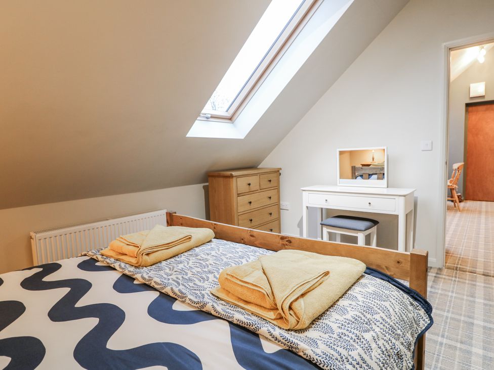 A bedroom with a bed and dresser at The Walnut Room - Windmill Country Retreats Wymondham near Buckminster